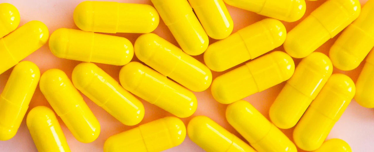 Visual representation of yellow vitamin capsules